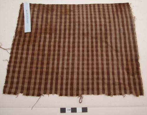 Organic, woven fiber, textile fragment, brown, tan stripes, selvage edge