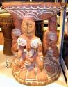 Large wooden stool with three carved figures - painted red, white and +