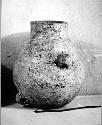 Ceramic jar, cylindrical neck, perforated handles at shoulder and base