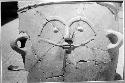 Large pottery burial urn with crude human face appliqued on ext. wall.