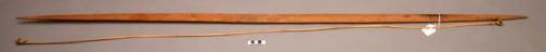 Light colored hard wood bow with bamboo bowstring and raffia (58")