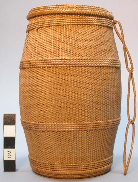 Small barrel-shaped basket with woven handle connecting base and cover