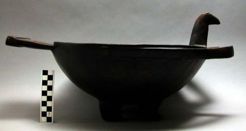 Bowl, carving of bird's head, wings, and tail. four legs