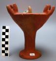 Incense burner in rust colored slip with three sets of three points on rim.  7.5