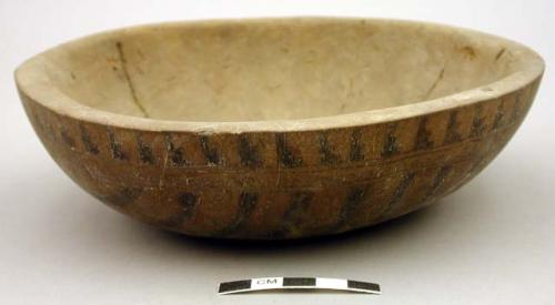 Gourd (probably used as bowl) with black lines on bottom