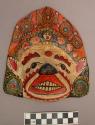 Papier mache mask - face painted white with polychrome design +