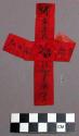 Print, black on red paper strips in cross configuration, black inscription