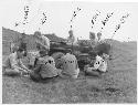 Gordon Willey & others seated around jeep in Viru Valley