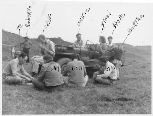 Gordon Willey & others seated around jeep in Viru Valley