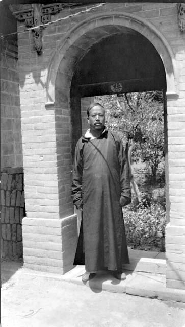 Man standing beneath arch