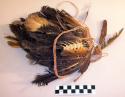 Tobacco net decorated with feathers, cocoons, and bones