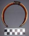 Pendant, carved ivory crescents, bound at center with leather and reptile skin