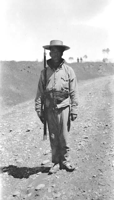 Man standing in dirt road