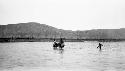 People crossing river on horses