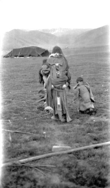 Woman and children walking towards tent