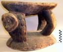 Wooden stool with one carved face