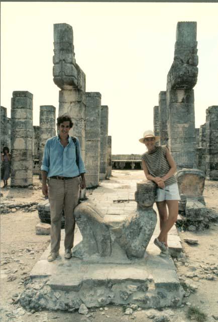 Two unidentified people flanking a Chacmool figure at Chitzen Itza