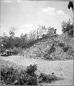 Pyramidal mound being destroyed for building material.