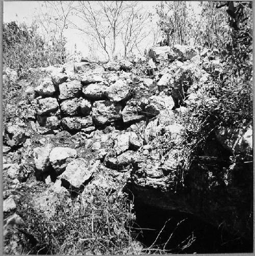 Outer face of city wall above cave, about 40m. West of SW gate