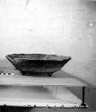Ceramic tripod bowl, flaring chipped rim
