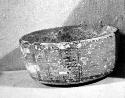 Ceramic bowl, flat base, painted linear pattern, chipped, worn