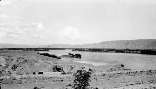 River running through desert by mountains