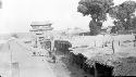 People on road by subterranean buildings