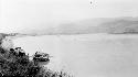 Person in boat on lake by mountains