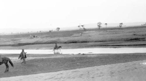 Person on pony crossing river