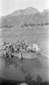 Men packing boat in river