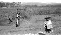 Children on dirt road near field