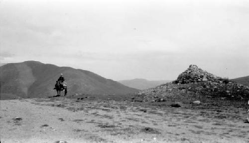 Person riding horse in mountains