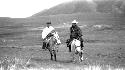 Men riding ponies in the desert