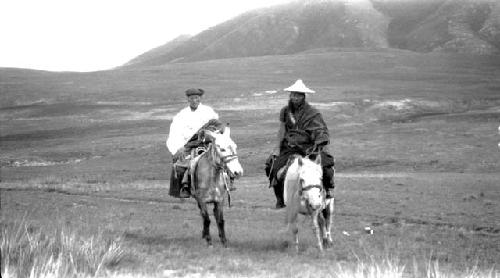 Men riding ponies in the desert