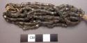 Bracelet, five strands of black tubular shell beads