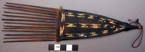 Inlaid wooden comb, string handle attached