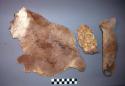 Pieces of buffalo skin, hair removed, loops made along one side; thong inserted