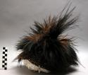 Feather cap, knitted base with cassowary feathers at top, used in +