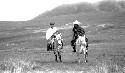 Men riding ponies in desert