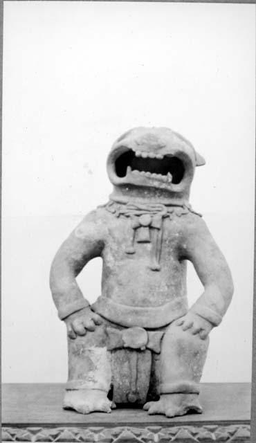 Seated pottery figure.  Head, hands and feet of a jaguar.  Large open mouth.