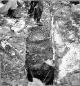 Stairway going down to a cenote from floor of a temple; cenote is below temple