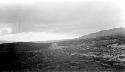 Barren, rocky road, hills in background