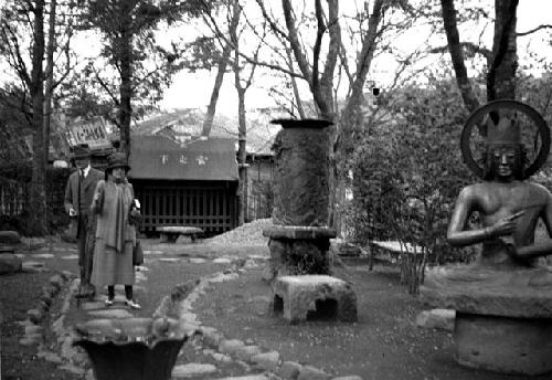 American man and woman walking in sculpture garden