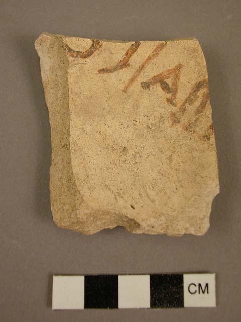 Black-on-yellow potsherd, apparently bearing spanish letters