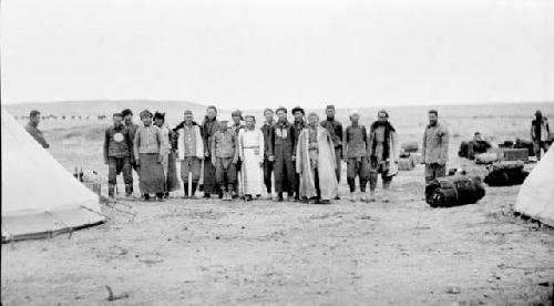 Group of people standing between tents