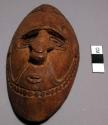 Small carved wooden mask - hung on baskets