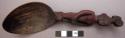 Wooden spoon, handle carved in human effigy: female, hands resting on flexed kne