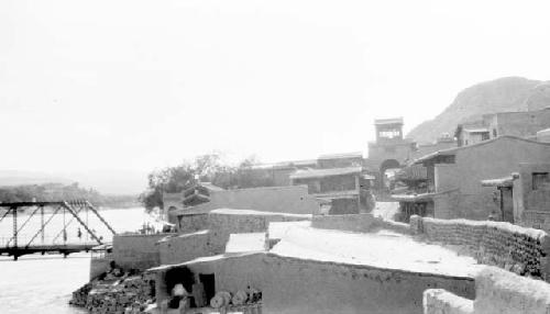 Buildings on waterfront near bridge