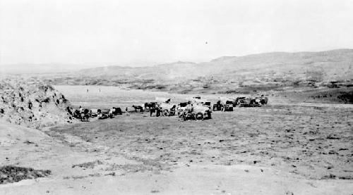 People with ponies pulling carts in desert