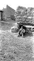 Person sitting against stone wall